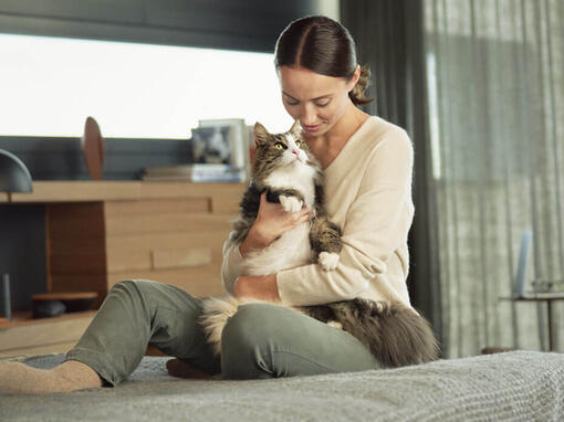 Woman holding cat on her lap